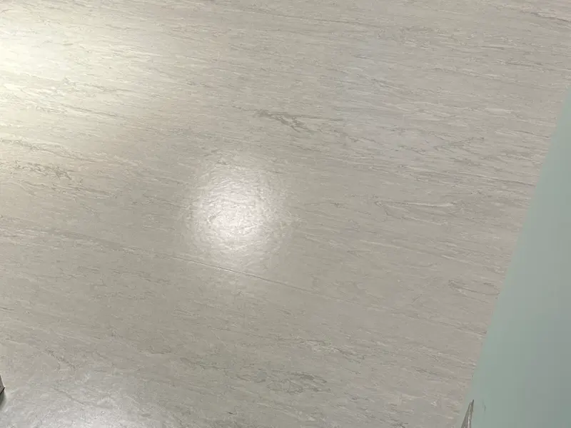 Marble-look sheet vinyl in a CBD clinic room after buffing and two coats of polish