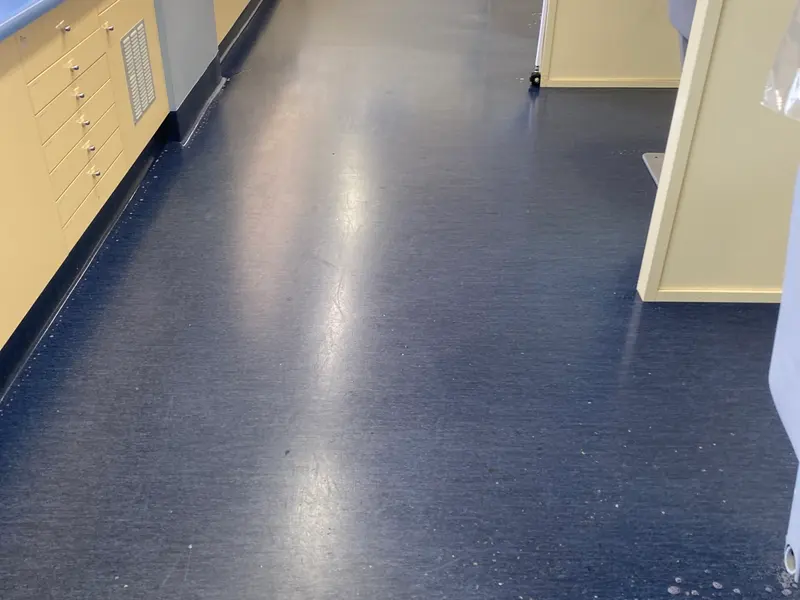 The same blue sheet vinyl glossy after three coats of polish